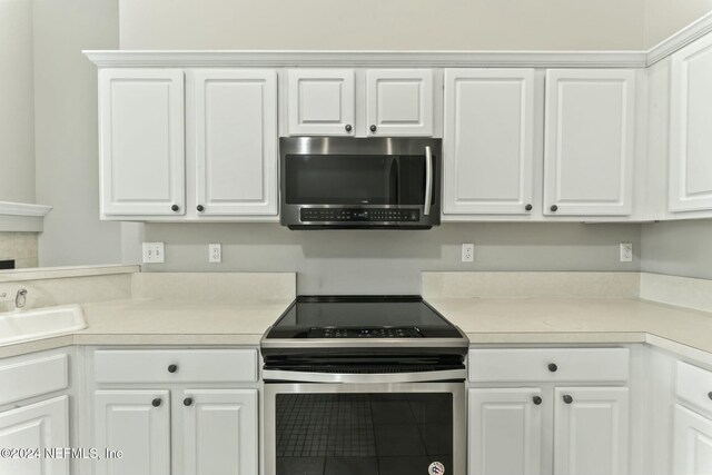 kitchen featuring white cabinets, sink, and stainless steel appliances