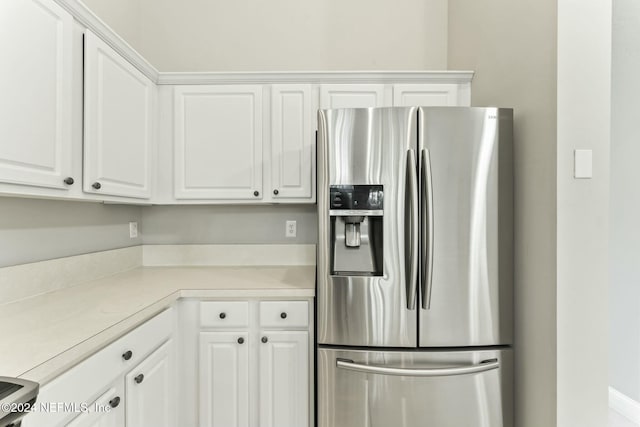 kitchen with white cabinets and stainless steel refrigerator with ice dispenser