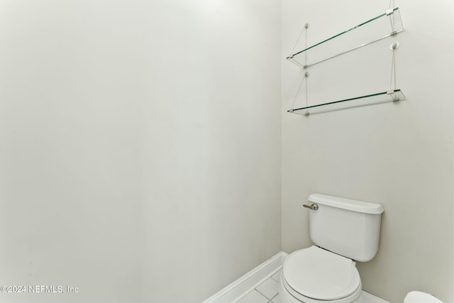 bathroom with tile patterned flooring and toilet