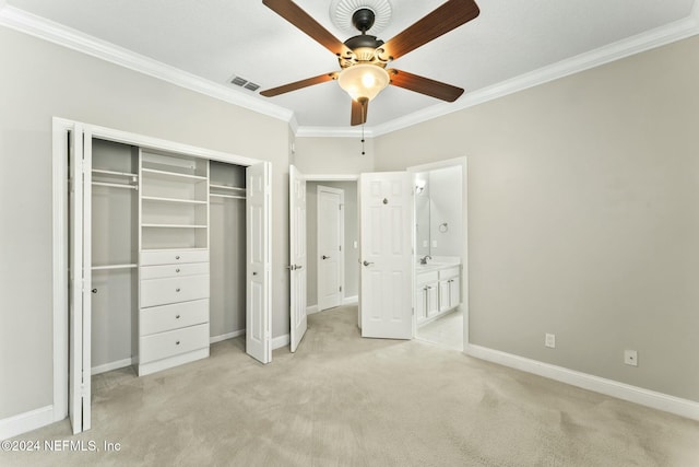 unfurnished bedroom featuring ensuite bath, ceiling fan, light colored carpet, a closet, and ornamental molding