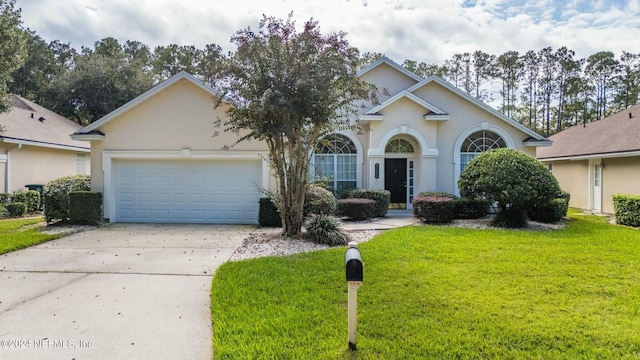 view of front of house with a front lawn and a garage