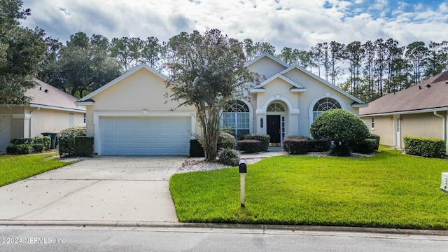 view of front facade with a front yard and a garage