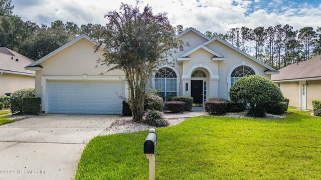 view of front facade with a front lawn and a garage