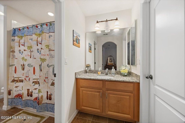 full bath with tile patterned flooring, vanity, and a shower with curtain