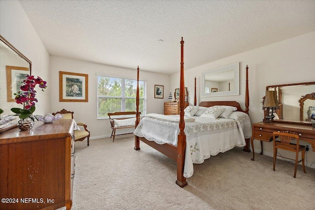 bedroom with a textured ceiling, baseboards, and light colored carpet