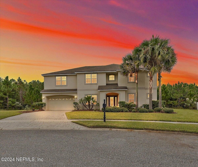 view of front of home with a lawn and a garage