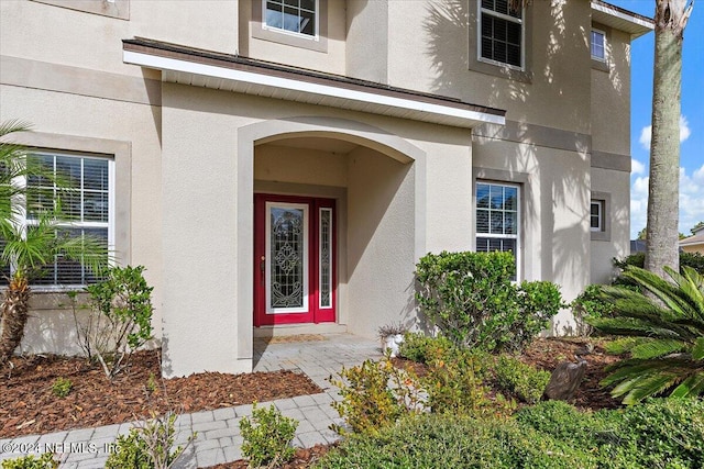 property entrance with stucco siding