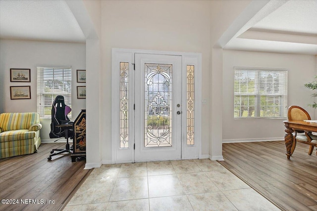 foyer entrance with light wood-type flooring and baseboards