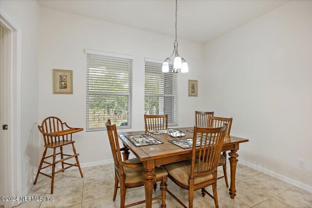 dining area with baseboards and light tile patterned floors