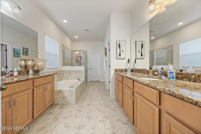 full bathroom featuring a stall shower, visible vents, a bath, and vanity