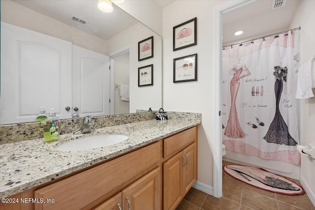 full bath with tile patterned floors, vanity, visible vents, and shower / tub combo with curtain