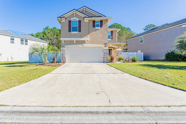 view of front property with a front yard and a garage