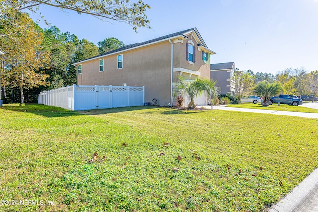 view of side of home featuring a lawn