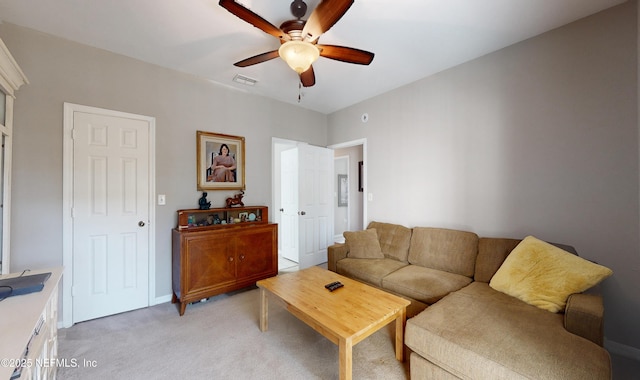 carpeted living room with ceiling fan