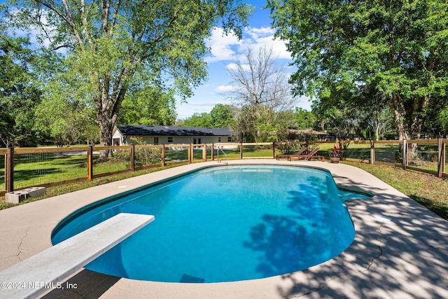 view of pool featuring a diving board