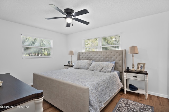 bedroom featuring a textured ceiling, dark hardwood / wood-style flooring, and ceiling fan