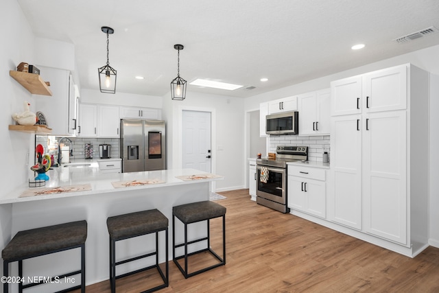 kitchen with sink, white cabinetry, and stainless steel appliances