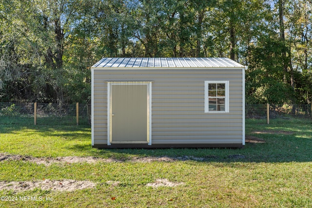 view of outbuilding with a yard