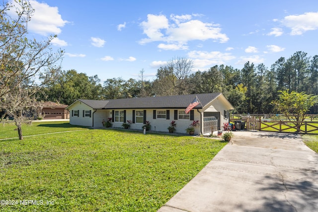 ranch-style home with a front lawn and a garage