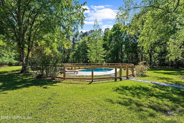 view of pool featuring a lawn