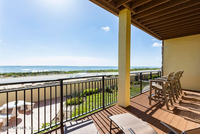 balcony featuring a beach view and a water view