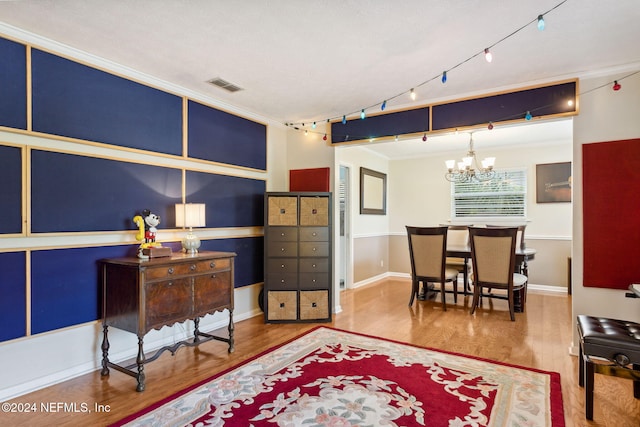 interior space featuring track lighting, wood-type flooring, and a chandelier