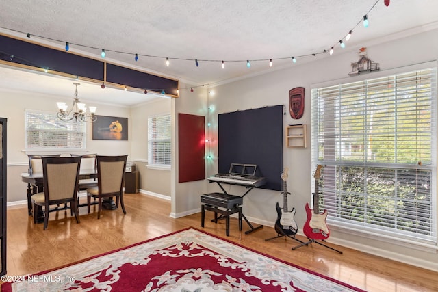 dining room with wood-type flooring, plenty of natural light, and crown molding