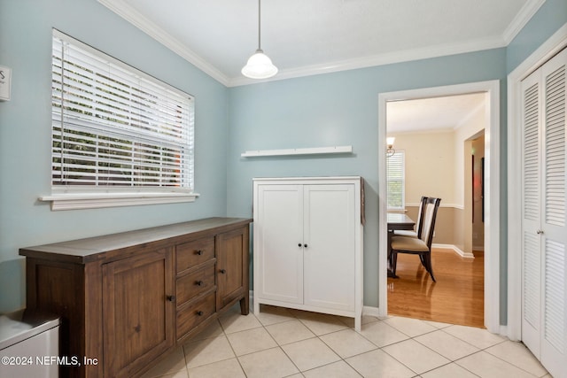 interior space featuring ornamental molding and light tile patterned flooring