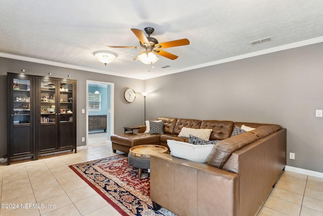 living room featuring ceiling fan, crown molding, and light tile patterned flooring