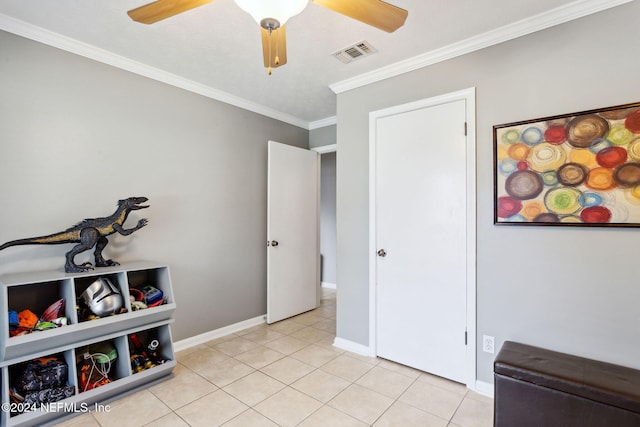 interior space with ceiling fan and crown molding