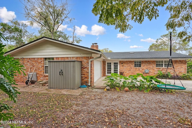 rear view of property featuring a garage