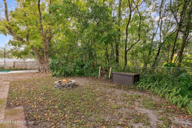 view of yard with an outdoor fire pit