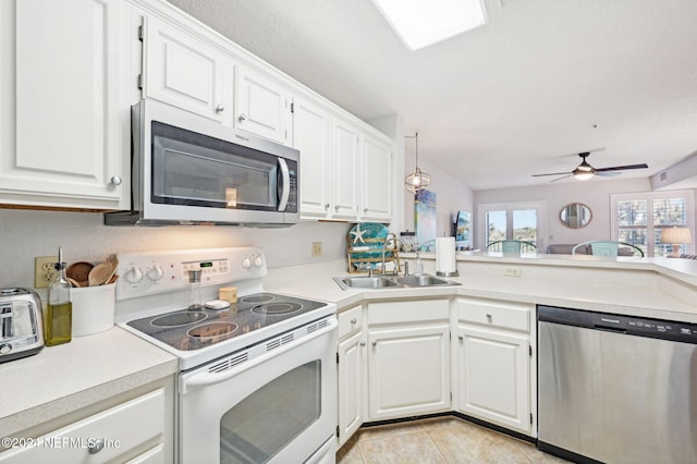 kitchen featuring appliances with stainless steel finishes, ceiling fan, sink, light tile patterned floors, and white cabinets