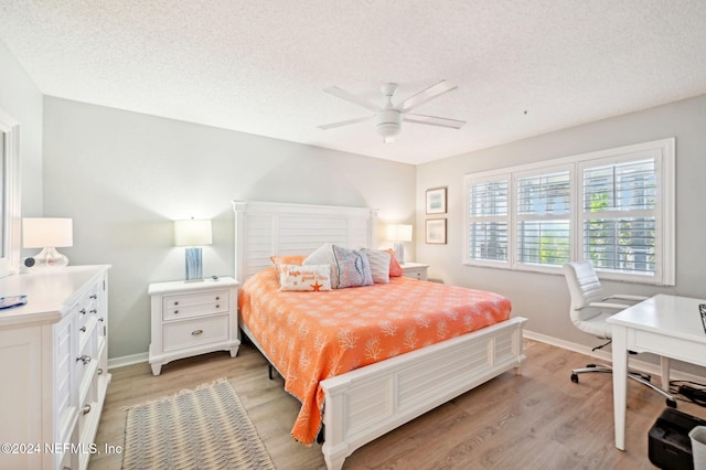 bedroom featuring a textured ceiling, light hardwood / wood-style flooring, and ceiling fan