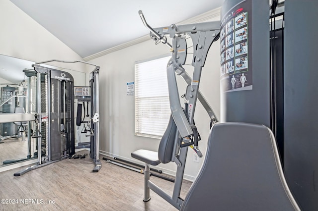 gym with hardwood / wood-style floors, crown molding, and vaulted ceiling