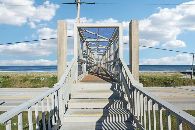 surrounding community featuring a beach view and a water view