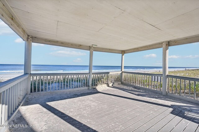 deck with a beach view and a water view