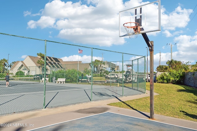 view of sport court featuring a yard and tennis court