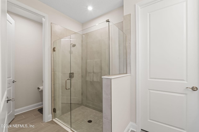 bathroom featuring a shower with shower door