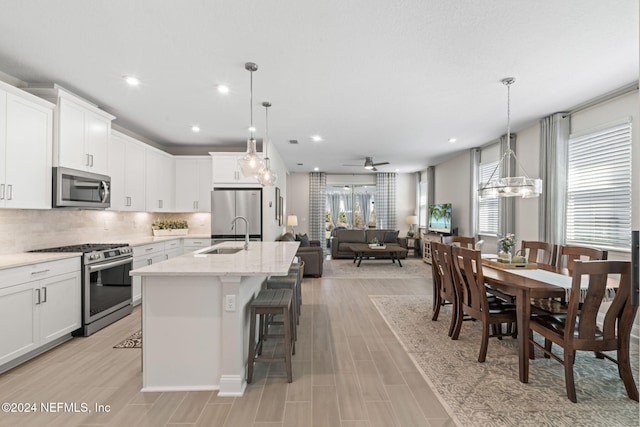 kitchen featuring white cabinets, a healthy amount of sunlight, and stainless steel appliances