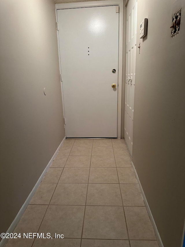 doorway featuring light tile patterned floors