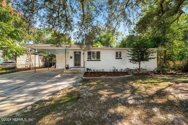 ranch-style home featuring a carport