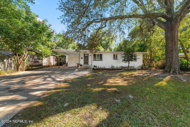 single story home with a carport and a front lawn