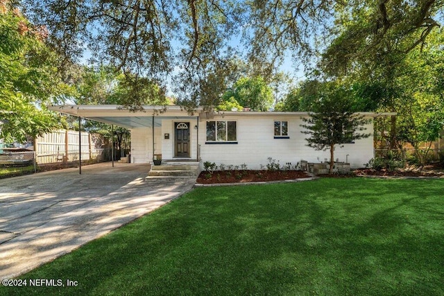 ranch-style home with a carport and a front yard