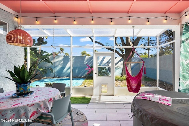 interior space with glass enclosure, fence, and a fenced in pool