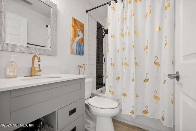 bathroom with wood finished floors, vanity, toilet, and shower / bath combo with shower curtain