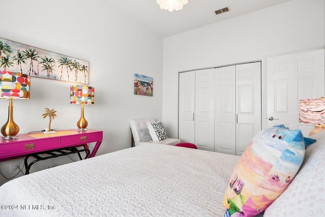 bedroom with a closet and visible vents