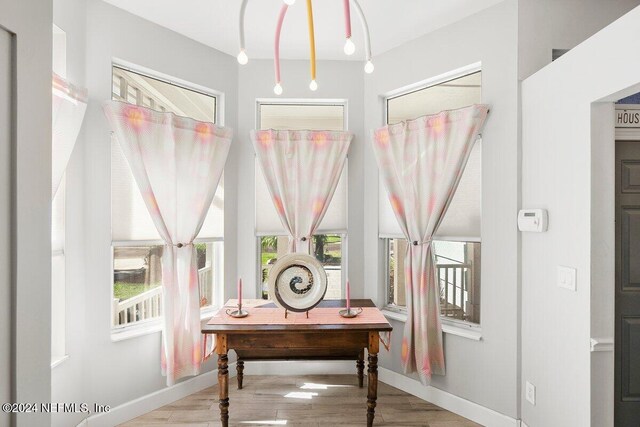 office area with light wood-style floors and baseboards