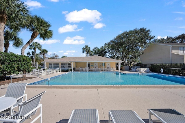 pool featuring a patio area and fence