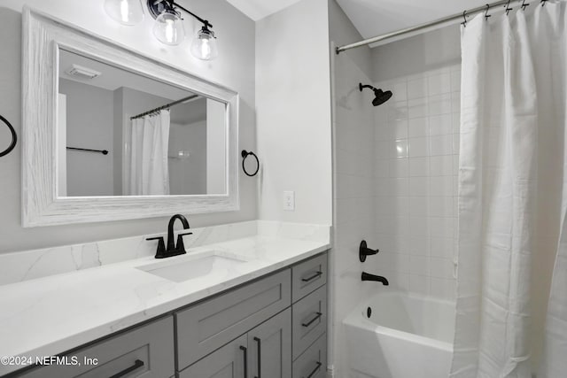 bathroom featuring vanity and shower / bathtub combination with curtain